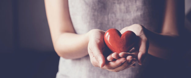 Asian woman holding red heart, health insurance, donation charity concept
